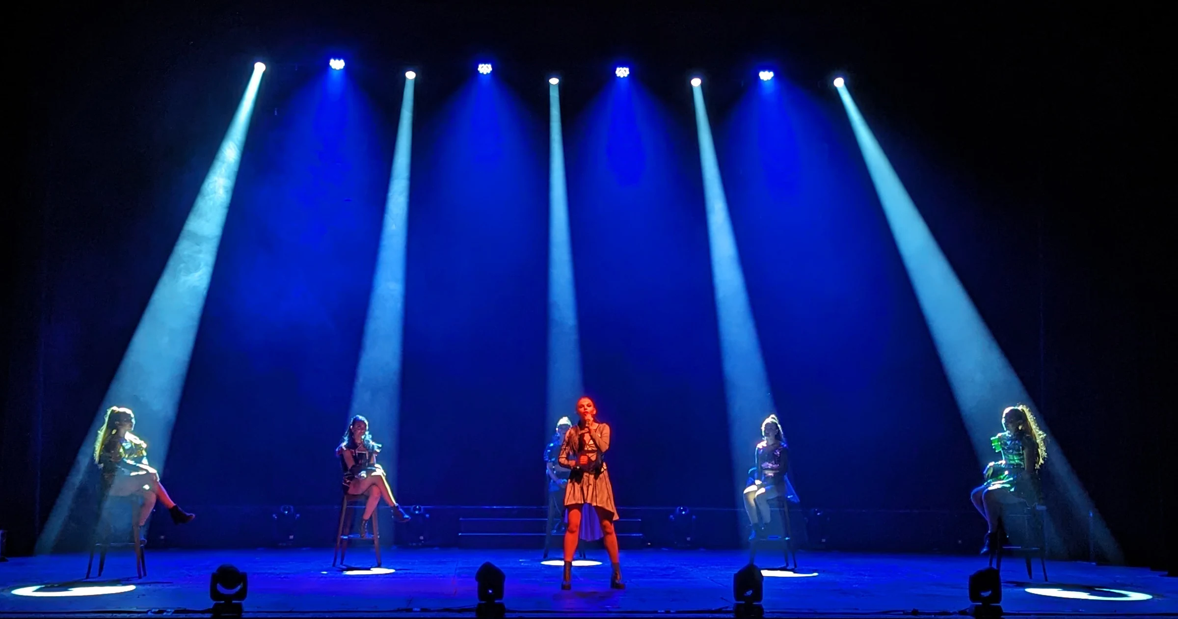 Beams of stage light above a live performance